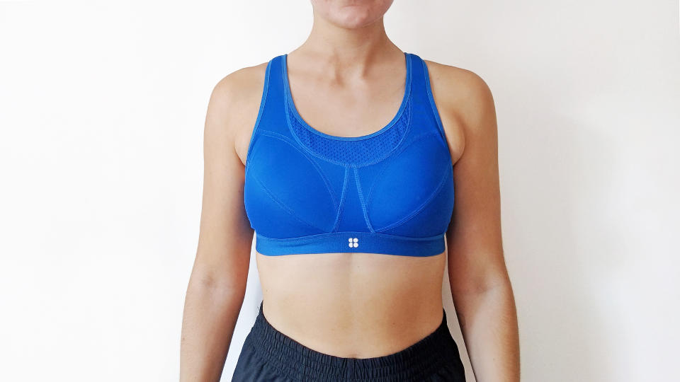 Woman wearing blue Sweaty Betty sports bra