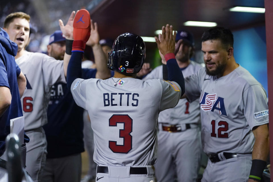 United States' Mookie Betts celebrates with teammates after scoring against Colombia on Mike Trout's single during the third inning of a World Baseball Classic game in Phoenix, Wednesday, March 15, 2023. (AP Photo/Godofredo A. Vásquez)