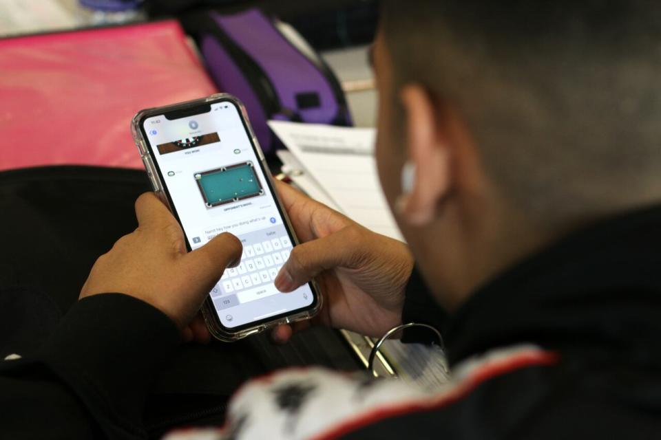 Teenagers are shown on cellphones, in closeup. 