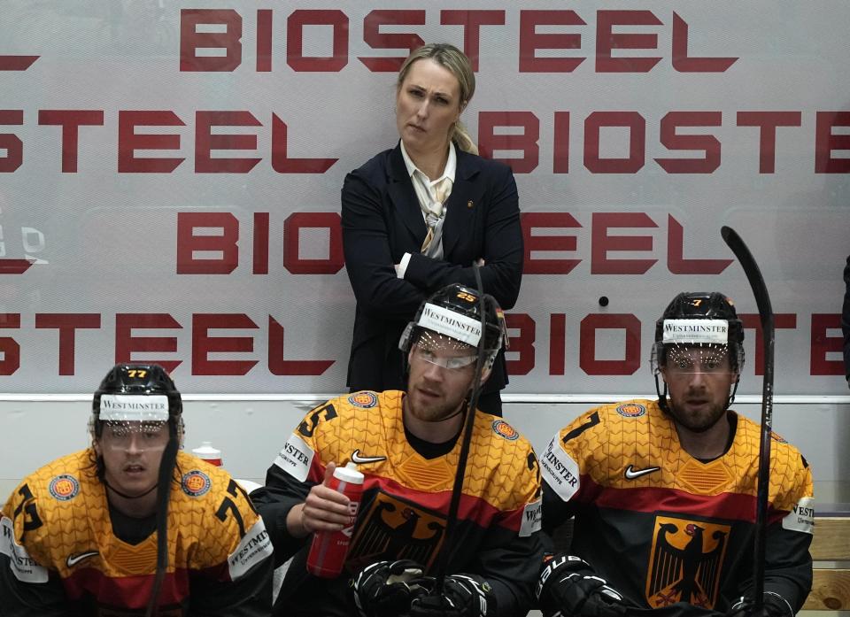 FILE - Germany's assistant coach Jessica Campbell stands behind players at the German bench during the group A Hockey World Championship match between France and Germany in Helsinki, Finland, Monday May 16, 2022. Jessica Campbell will become the first woman to work on the bench of an NHL franchise after the Seattle Kraken hired her as an assistant coach Wednesday, July 3, 2024.(AP Photo/Martin Meissner, File)