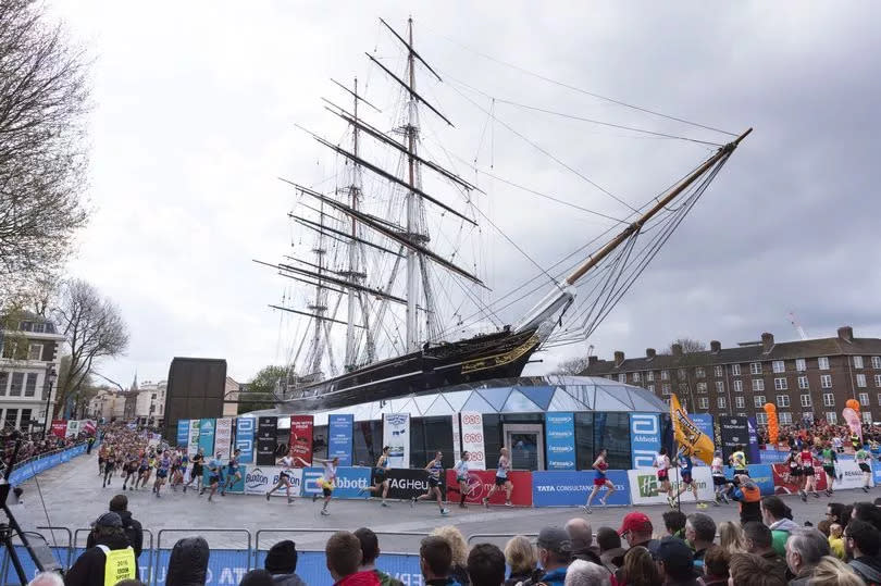 Runners run around the Cutty Sark ship