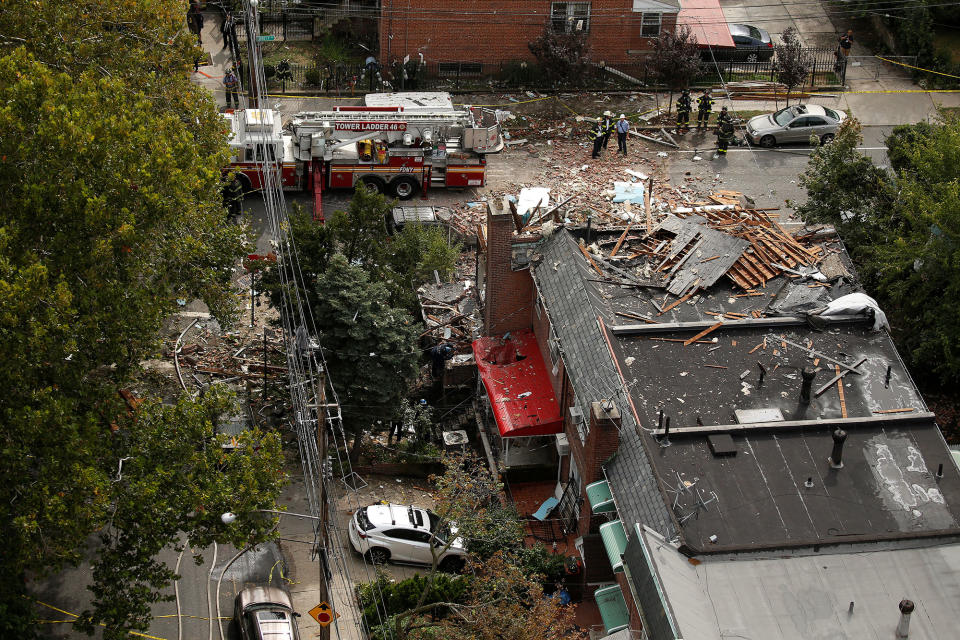 <p>Investigators stand near a home that was destroyed by an explosion in the early morning in the Bronx borough of New York on Sept. 27, 2016. (Carlo Allegri/Reuters) </p>