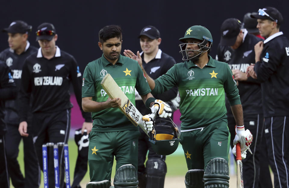 Pakistan's captain Sarfaraz Ahmed, right, pat on the shoulder teammate Babar Azam for scoring a century at the end of the Cricket World Cup match between New Zealand and Pakistan at the Edgbaston Stadium in Birmingham, England, Wednesday, June 26, 2019. Pakistan beat New Zealand by 6 wickets with 5 balls remaining. (AP Photo/Rui Vieira)