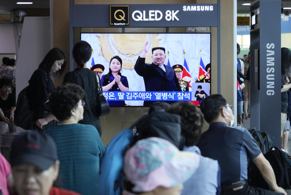 A TV screen shows an image of North Korean leader Kim Jong Un and his daughter, left, attending a paramilitary parade ceremony marking North Korea's 75th founding anniversary in Pyongyang, North Korea, during a news program at the Seoul Railway Station in Seoul, South Korea, Saturday, Sept. 9, 2023. (AP Photo/Ahn Young-joon)