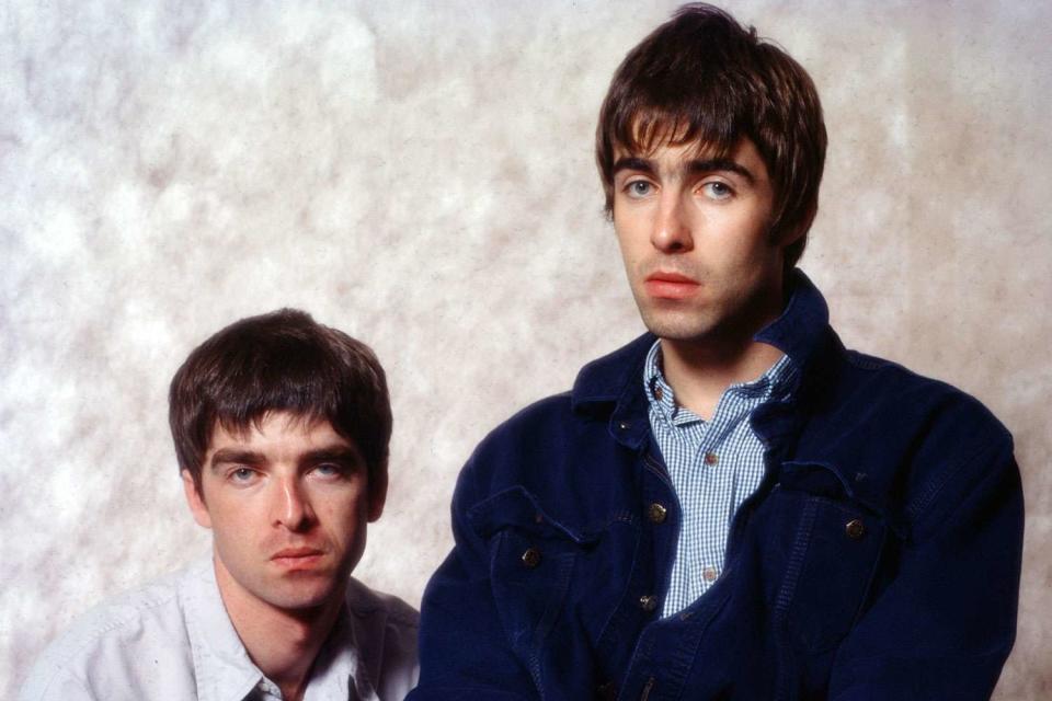 <p>Koh Hasebe/Shinko Music/Getty</p> Noel Gallagher and Liam Gallagher of Oasis in September 1994