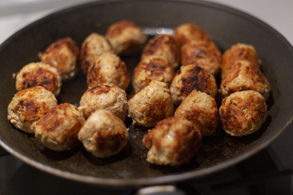 Meatballs cooking in a skillet