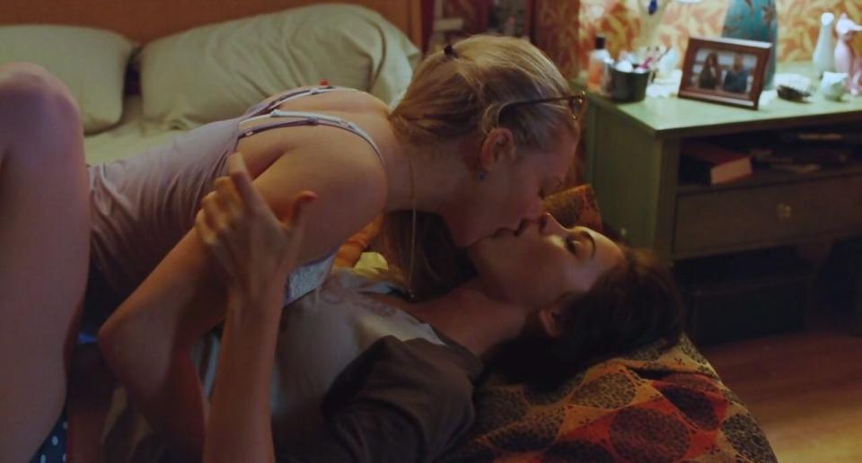 Needy kissing Jennifer on her bed