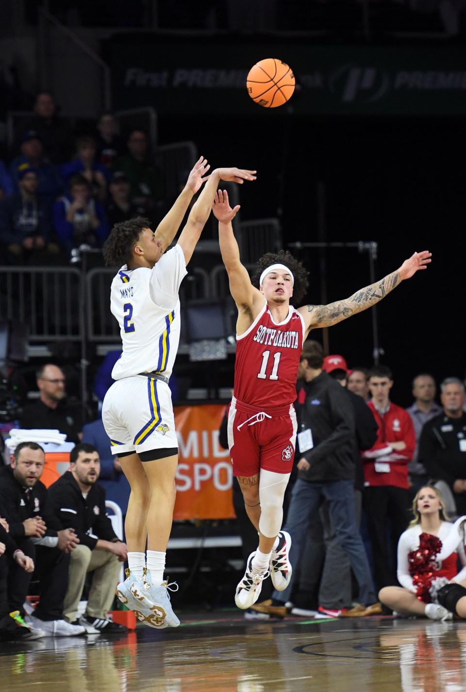 South Dakota State's Zeke Mayo shoots a three-pointer over South Dakota's Mason Archambault in a semifinal game on Monday, March 7, 2022, at the Summit League Tournament at the Denny Sanford Premier Center in Sioux Falls.