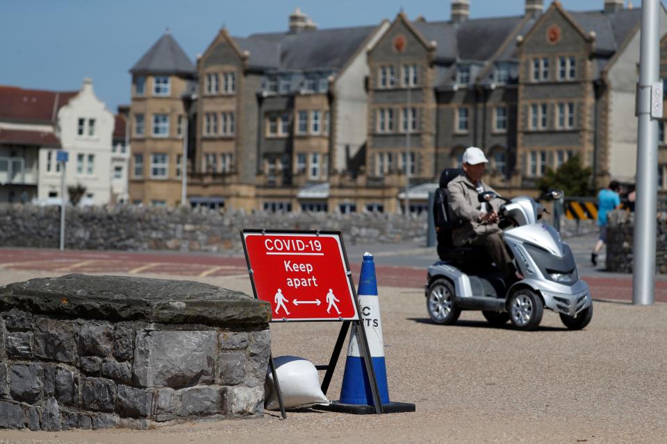 A sign displaying advice on social distancing is displayed at the beach in Weston-super-Mare, south west England on May 27, 2020, as lockdown measures are eased during the novel coronavirus COVID-19 pandemic. (Photo by Adrian DENNIS / AFP) (Photo by ADRIAN DENNIS/AFP via Getty Images)