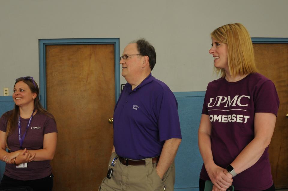 Mary Ryman of UPMC, left, David Bertoty, chief nursing officer, vice president, patient care services at Somerset UPMC, and Sarah Deist, Somerset UPMC spokeswoman work at a Minutes Matter event.