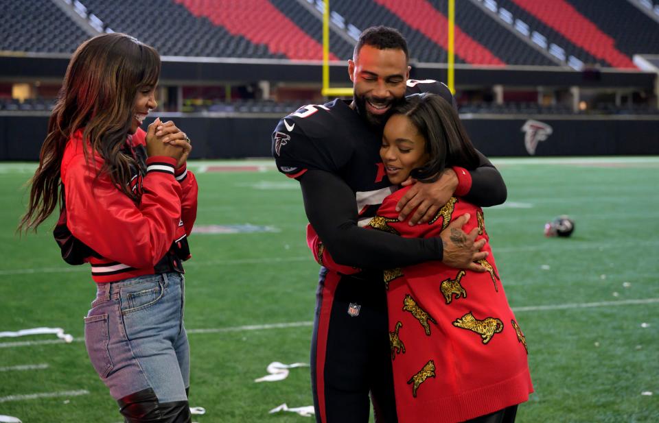 A fumble-prone running back (Omari Hardwick, center) is magically turned into a gridiron superstar when his daughter (Marsai Martin, right) plays him in a video game in "Fantasy Football."
