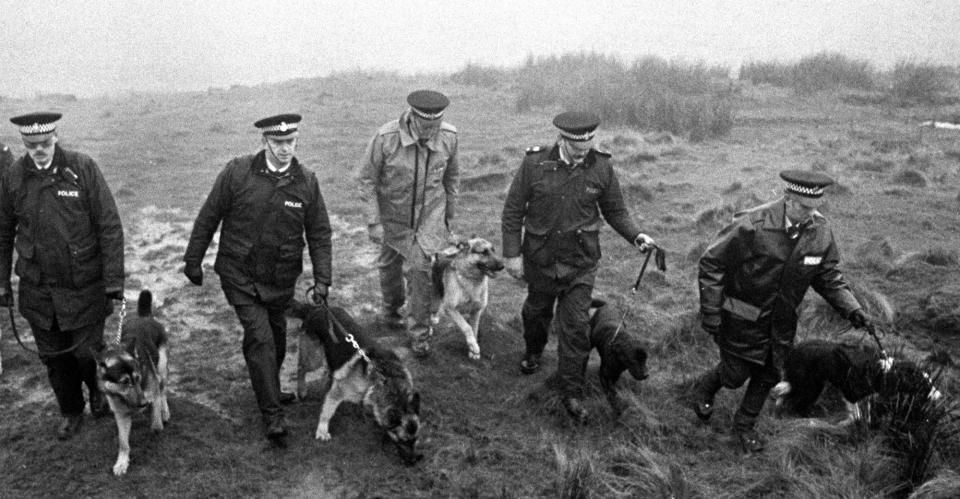 A 1986 photo shows police using specially trained sniffer dogs on Saddleworth Moor, near Oldham, to search for Keith Bennett, one of the victims of Ian Brady (PA Images)