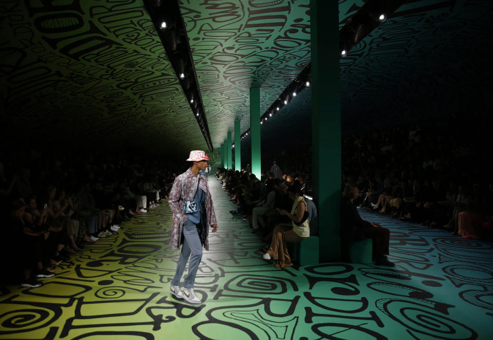 A model walks the runway wearing the Christian Dior pre-fall 2020 men's fashion collection during Art Basel on Tuesday, Dec. 3, 2019, in Miami. (AP Photo/Brynn Anderson)