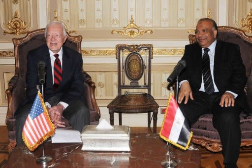 Egyptian Parliament Speaker Saad al-Katatni (R) meets withs former US president Jimmy Carter in his office in Cairo. Carter had arrived on Sunday with a delegation from his Carter Center to monitor the polls