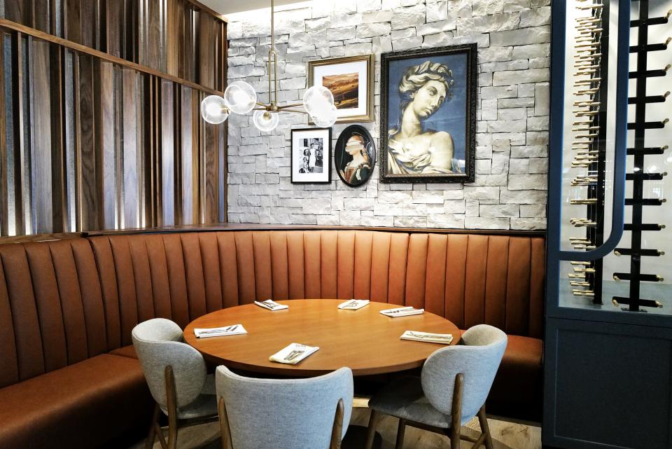 Artwork graces the walls of Toscana, an Italian steakhouse in the Red Cedar Development across from Frandor Tuesday, Aug. 22, 2023. The restaurant will open Aug. 31.