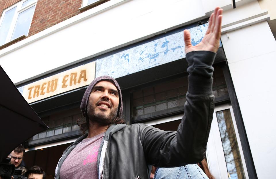 FILE - In this Thursday, March 26, 2015 file photo, Russell Brand speaks at the opening of The Trew Era Cafe, a social enterprise community project on the New Era estate in east London. Comedian turned political activist Russell Brand has changed his mind and is no longer urging people not to vote in Thursday's general election. Instead, Brand on Monday, May 4, 2015 used his YouTube channel to urge his more than 1 million subscribers to back the Labour Party's Ed Miliband. (Photo by Joel Ryan/Invision/AP, File)