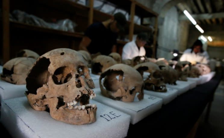 Biological anthropologists examine skulls discovered in the cylindrical edifice near Templo Mayor (Reuters)