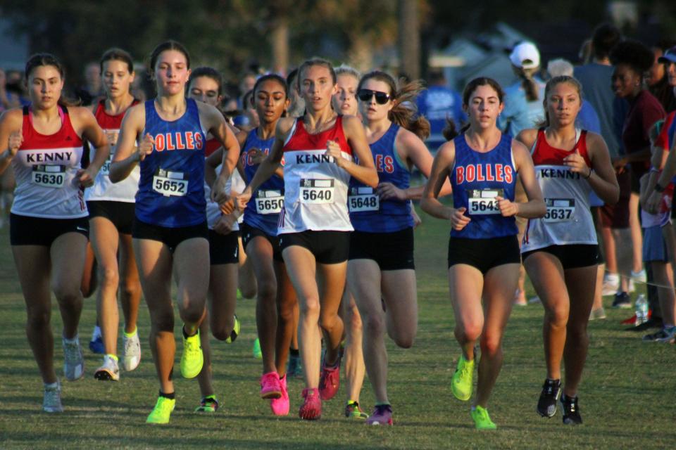 Runners including Bishop Kenny's Stephanie Grden (5630), Emily Wheldon (5640) and Tessa Massa (5637) and Bolles' Sofie Stam (5652), Emily Loftin (5648) and Estella Bruneau (5643) lead the pack during the FHSAA District 2-2A high school girls cross country meet.