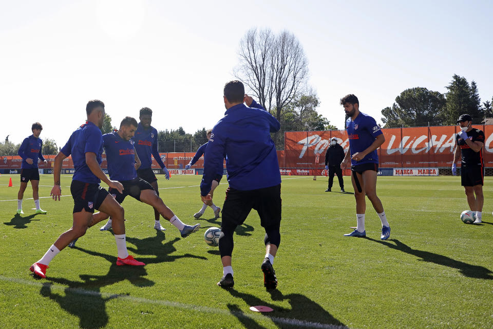 In this photo provided by Atletico Madrid, team players take part in the first group training session in Madrid, Spain, Monday May 18, 2020. All Spanish league clubs can begin group training sessions this week despite stricter lockdown restrictions remaining in place in parts of Spain because of the coronavirus pandemic. (Atletico de Madrid via AP)