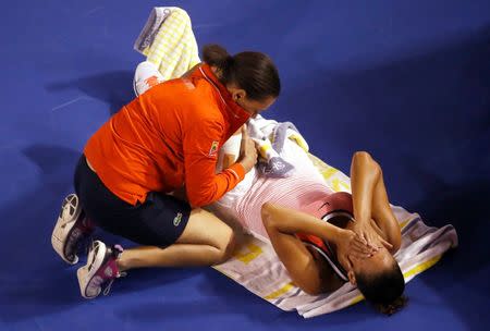 Madison Keys of the U.S. reacts as she receives medical attention during her fourth round match against China's Zhang Shuai at the Australian Open tennis tournament at Melbourne Park, Australia, January 25, 2016. REUTERS/Jason Reed