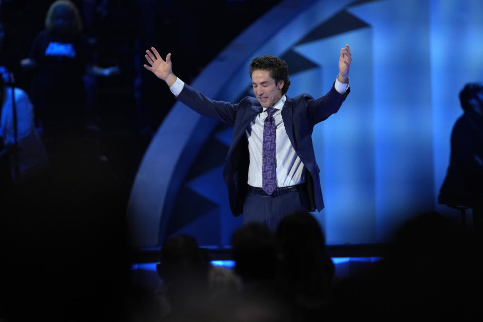 Pastor Joel Osteen prays during a service at Lakewood Church, Sunday, Feb. 18, 2024, in Houston. Osteen welcomed worshippers back to Lakewood Church for the first time since a woman with an AR-style opened fire in between services at his Texas megachurch last Sunday. (AP Photo/David J. Phillip)