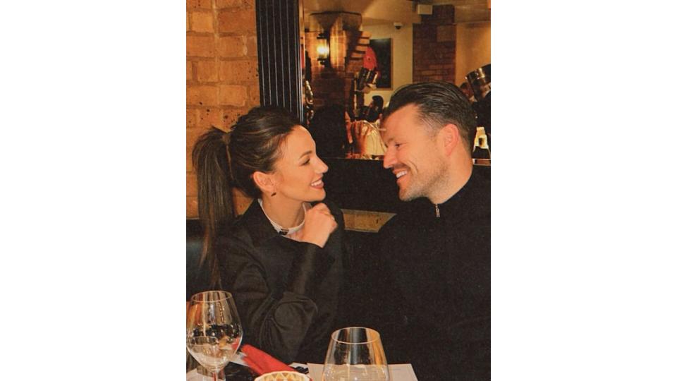 Mark and Michelle Keegan smiling at eachother