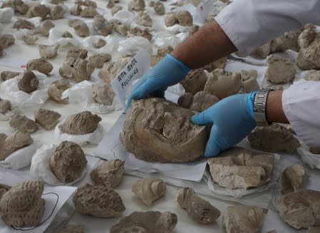 Conservators work on pieces of statues damaged by the Taliban, in National Museum of Afghanistan in Kabul