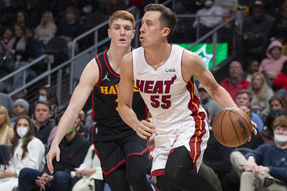 Miami Heat guard Duncan Robinson (55) dribbles past Atlanta Hawks guard Kevin Huerter (3) during the second half of an NBA basketball game Friday, Jan. 21, 2022, in Atlanta. (AP Photo/Hakim Wright Sr.)