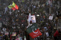 Supporters of Pakistan's former Prime Minister Imran Khan's 'Pakistan Tehreek-e-Insaf' party attend a rally, in Rawalpindi, Pakistan, Saturday, Nov. 26, 2022. Khan said Saturday his party was quitting the country's regional and national assemblies, as he made his first public appearance since being wounded in a gun attack earlier this month. (AP Photo/Anjum Naveed)