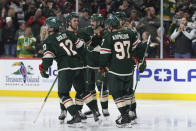 Minnesota Wild left wing Matt Boldy (12) celebrates with teammates after scoring during the third period of an NHL hockey game against the San Jose Sharks,Thursday, March 28, 2024, in St. Paul, Minn. (AP Photo/Abbie Parr)