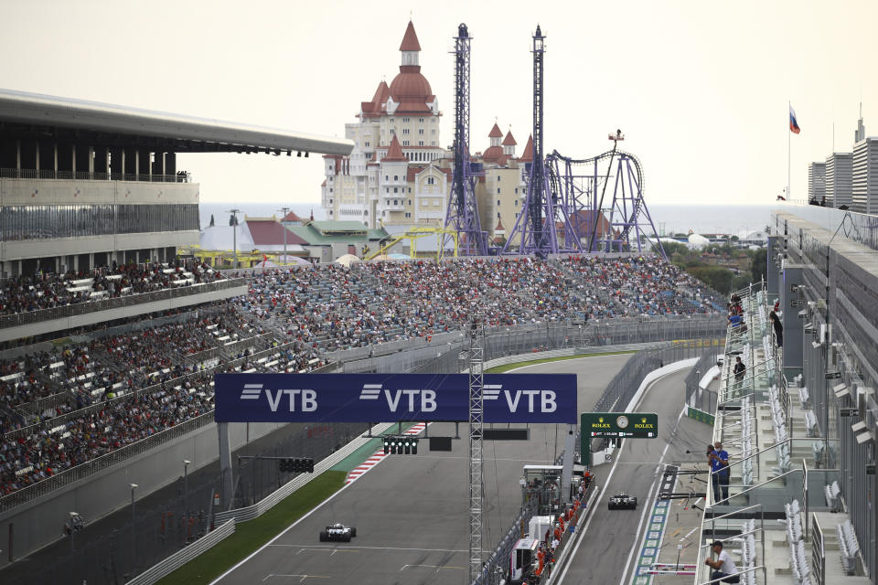 Spectators are on the stands during the qualification for the upcoming Russian Formula One Grand Prix, at the Sochi Autodrom circuit, in Sochi, Russia, Saturday, Sept. 26, 2020. The Russian Formula One Grand Prix will take place on Sunday. (Bryn Lennon/Pool Photo via AP)