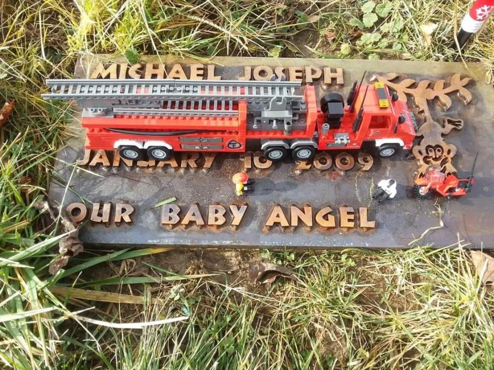 The tombstone of Molly McGuire's first child, Michael. McGuire continues to share the story of Michael to others, emphasizing the importance for patients to advocate for themselves.