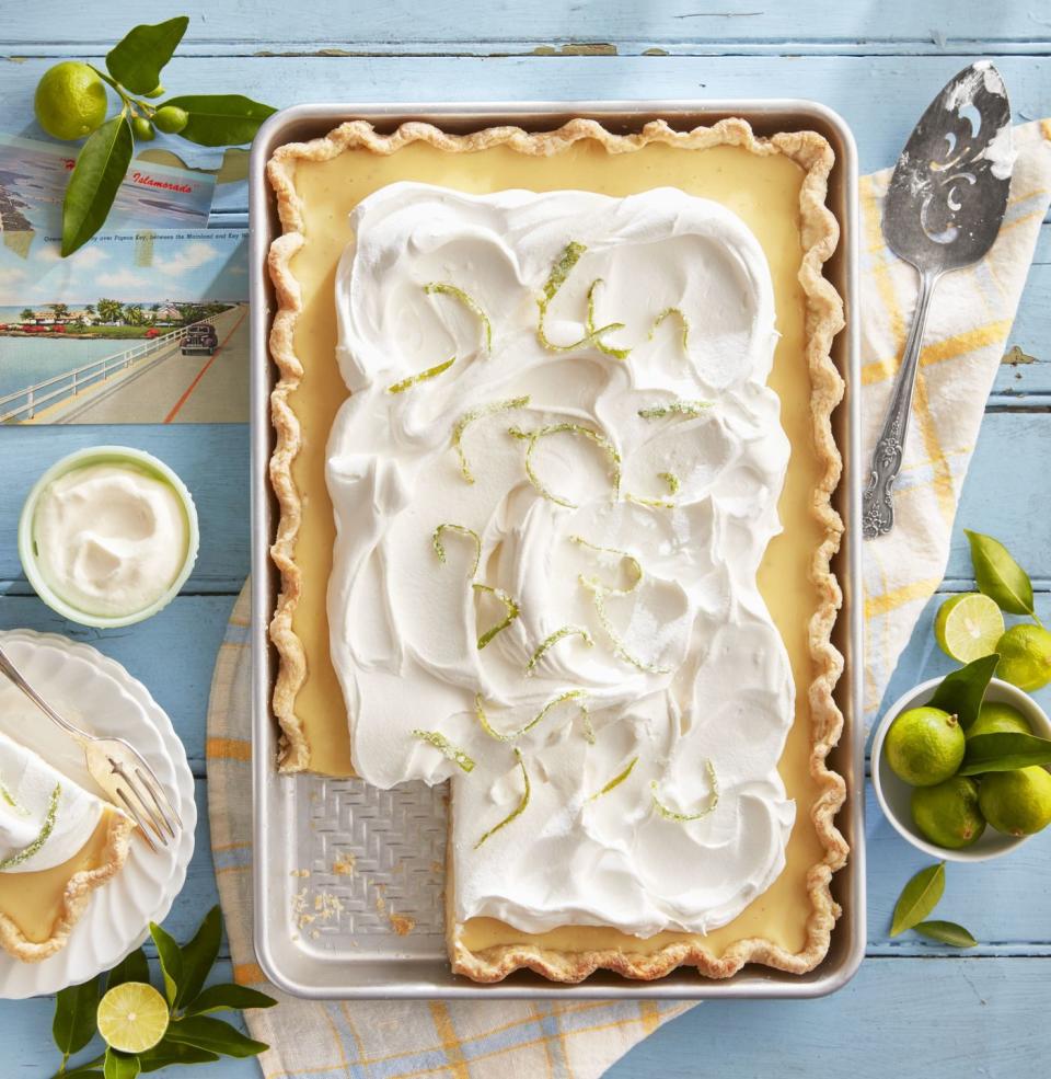 key lime slab pie topped with whipped cream and candied lime zest