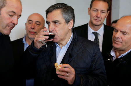 Francois Fillon, former French Prime Minister, member of the Republicans political party and 2017 presidential election candidate of the French centre-right drinks a glass of wine as he visits a farm in Cambo les Bains, France March 25, 2017. REUTERS/Regis Duvignau