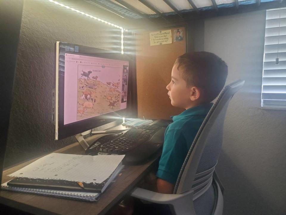 Marcos Fajardo, 6, works at his desk in his family’s playroom. His mother, Joanna Palmer, helps him get through the virtual school day while juggling her full-time job from home.