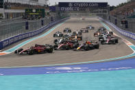 Ferrari driver Charles Leclerc of Monaco leads the field at the start of the Formula One Miami Grand Prix auto race at the Miami International Autodrome, Sunday, May 8, 2022, in Miami Gardens, Fla. (AP Photo/Darron Cummings)