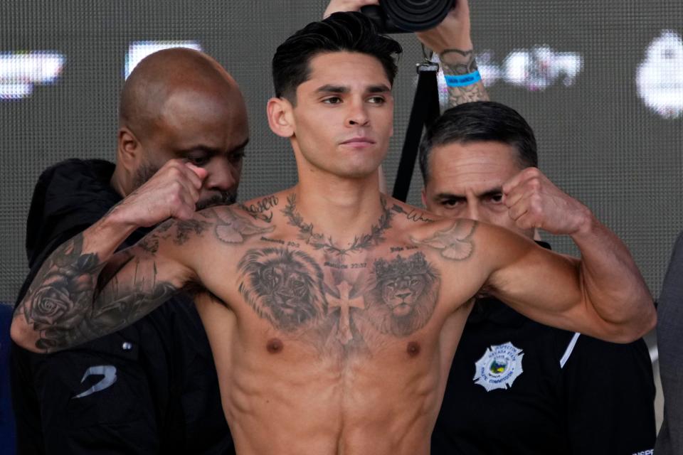 Ryan Garcia poses on the scale during a weigh-in Friday, April 21, 2023, in Las Vegas. Garcia is scheduled to fight Gervonta Davis in a catchweight boxing bout in Las Vegas on Saturday. (AP Photo/John Locher)