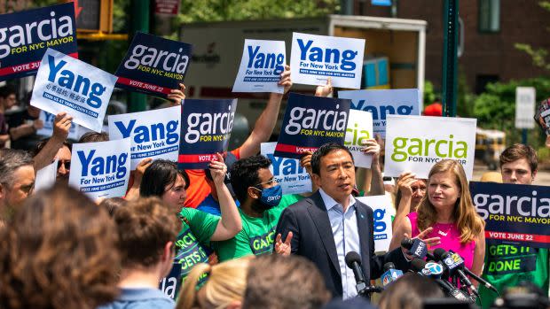 A photograph of Andrew Yang and Kathryn Garcia standing amongst supporters