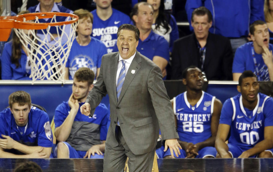 Kentucky head coach John Calipari works from the sideline against Wisconsin during the second half of the NCAA Final Four tournament college basketball semifinal game Saturday, April 5, 2014, in Arlington, Texas. Kentucky won 74-73. (AP Photo/Tony Gutierrez)