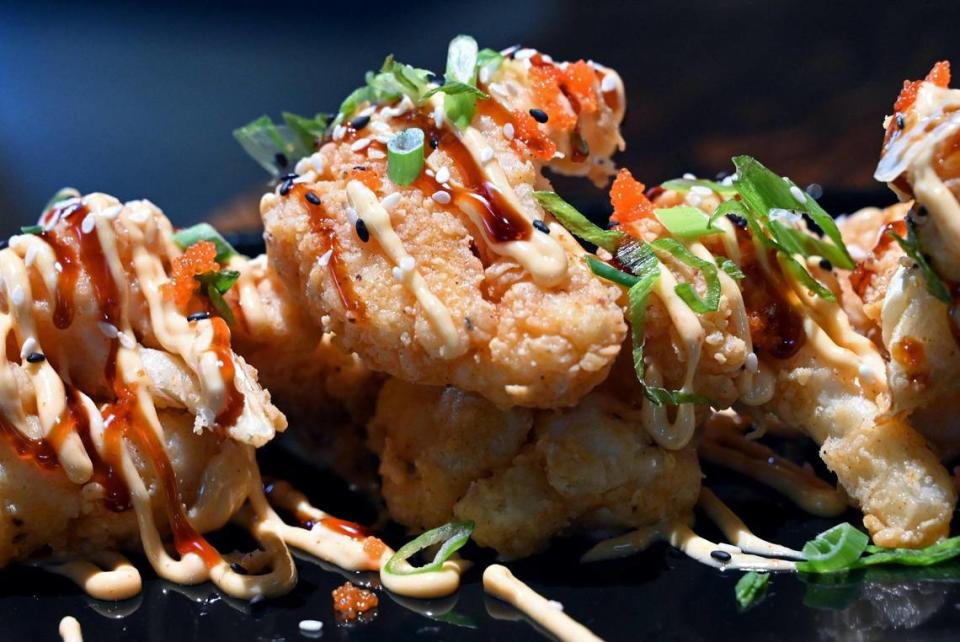 The Woodward American Grill’s dynamite cauliflower, drizzled with unagi sauce, spicy mayo, green onions, masago and toasted sesame seeds, photographed Wednesday, April 26, 2023 in Fresno. The Woodward has opened in the RiverView Shopping Center at Fort Washington and Friant roads.
