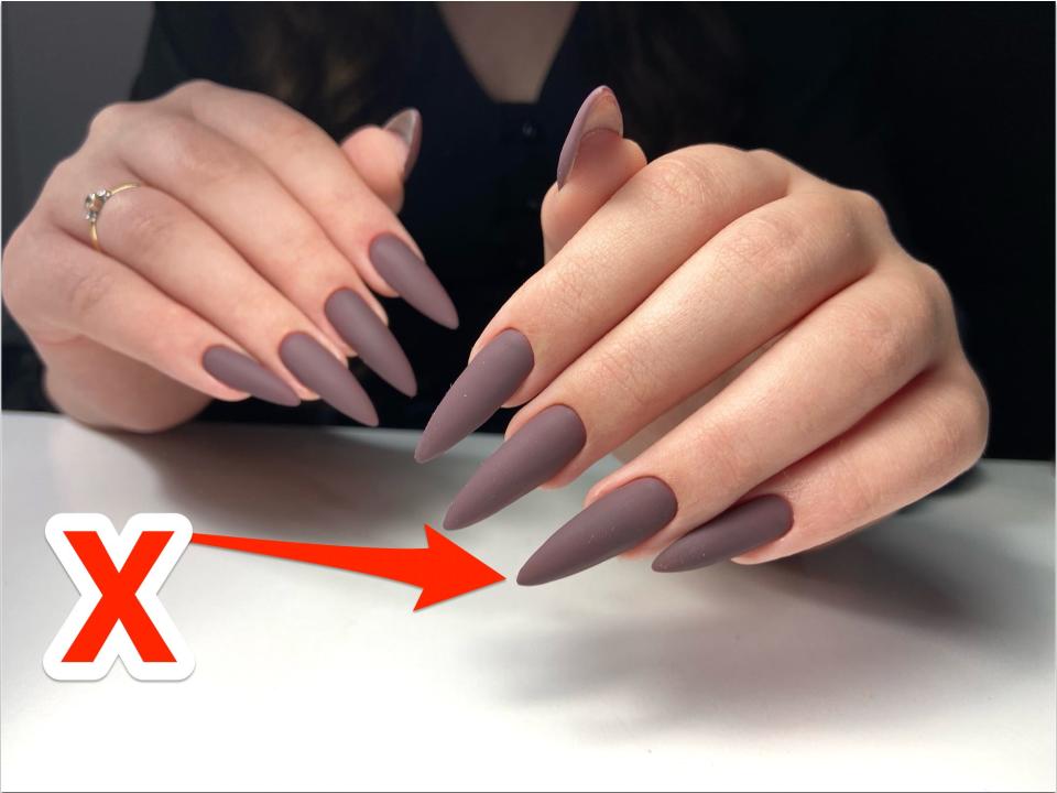 An x pointing at matte nails.