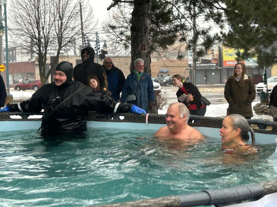 Crystal Soukkala and Eric Mink hang out in the pool after their plunge on Saturday, Jan. 27, 2024 with the Chippewa County Sheriff's Department volunteer lifeguard.