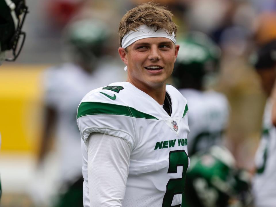 Zach Wilson smiles during a preseason game.