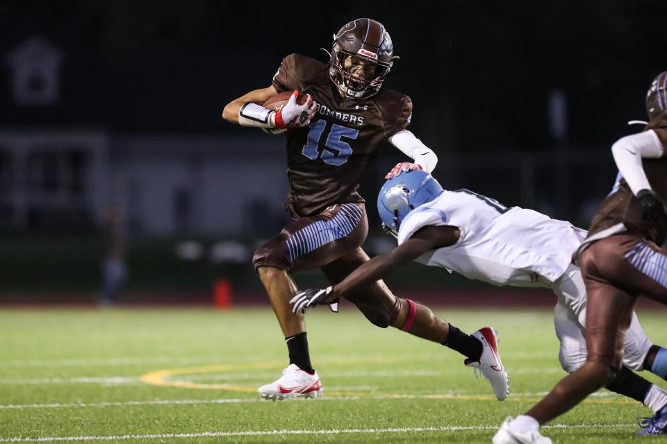 Wide receiver Manuel Sepulveda (15) of East Rochester/Gananda stiff arms Bishop Kearney/Rochester Prep/RACS defender Tajmir Mullens (6).