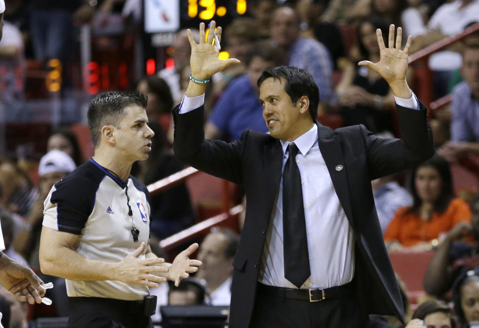 Miami Heat head coach Erik Spoelstra, right, gestures as he argues a call with official Eli Roe during the double overtime of an NBA basketball game in Miami, Friday, April 4, 2014. The Timberwolves won 122-121. (AP Photo/Alan Diaz)