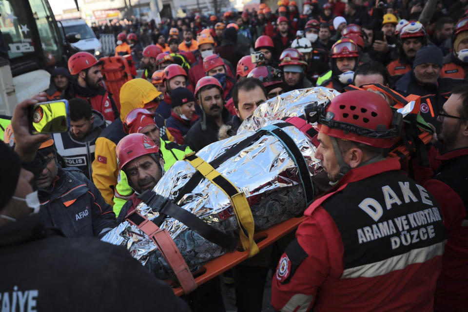 Members of rescue services carry a wounded man, that was found in the rubble of a building destroyed on Friday's earthquake in Elazig, eastern Turkey, Saturday Jan. 25, 2020. Rescue workers were continuing to search for people buried under the rubble of apartment blocks in Elazig and neighbouring Malatya. Mosques, schools, sports halls and student dormitories were opened for hundreds who left their homes after the quake (IHH/ Humanitarian Relief Foundation via AP)