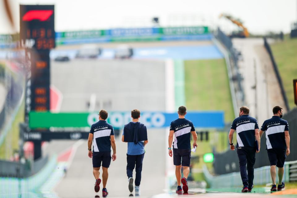 Driver Pierre Gasly of Scuderia AlphaTauri and his engineers walk the track at the Circuit of the Americas ahead of the 2021 United States Grand Prix.