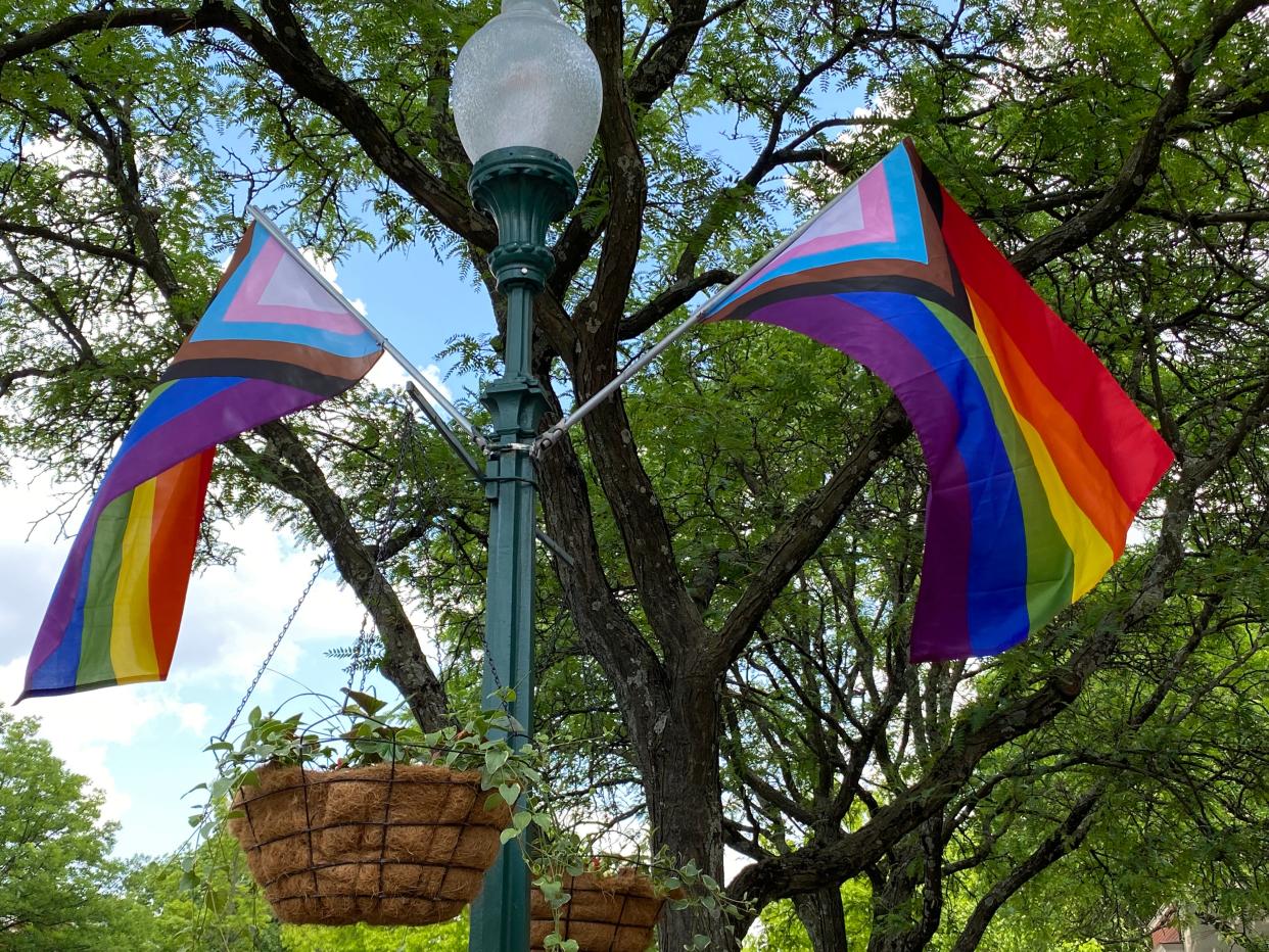 Progress Pride flags are shown hanging in downtown Worthington.