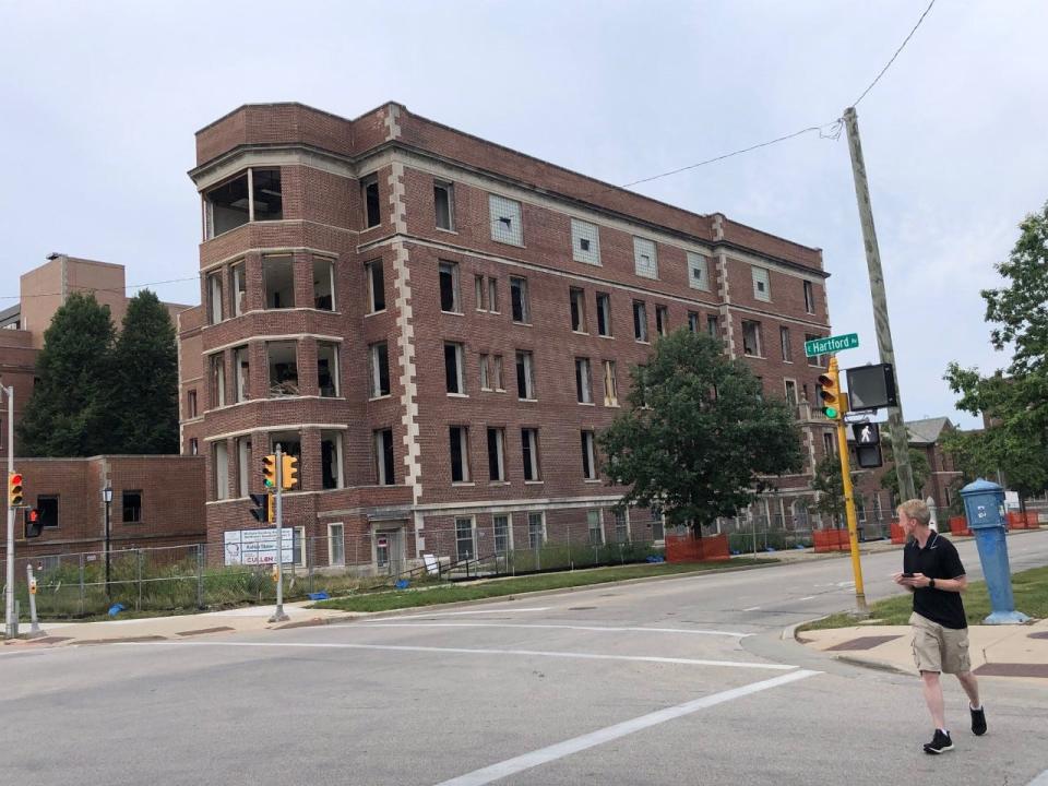 Demolition work at University of Wisconsin-Milwaukee's former Columbia Hospital continues after a judge refused to order a halt to the work.