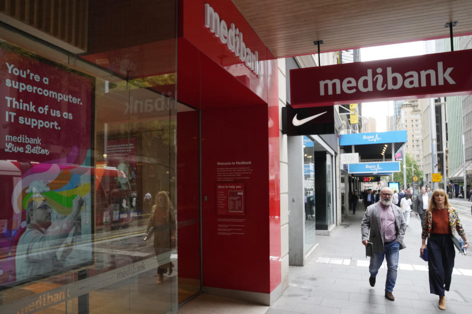 People walk past a Medibank branch in Sydney, Thursday, Oct. 20, 2022. Medibank health insurer is being extorted for customers' data in the nation's second major cybersecurity breach in a month, an official says. (AP Photo/Rick Rycroft)